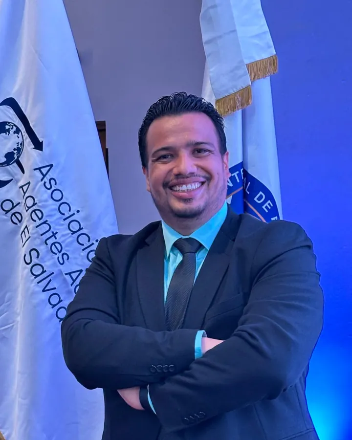 Marco Antonio Cruz Hernández, customs broker at MACH Customs Agency, next to the ASODAA flag